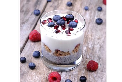 Gesundes Frühstück aus Milch, Blauberen, Heidelbeeren, Chiasamen und Müsli.